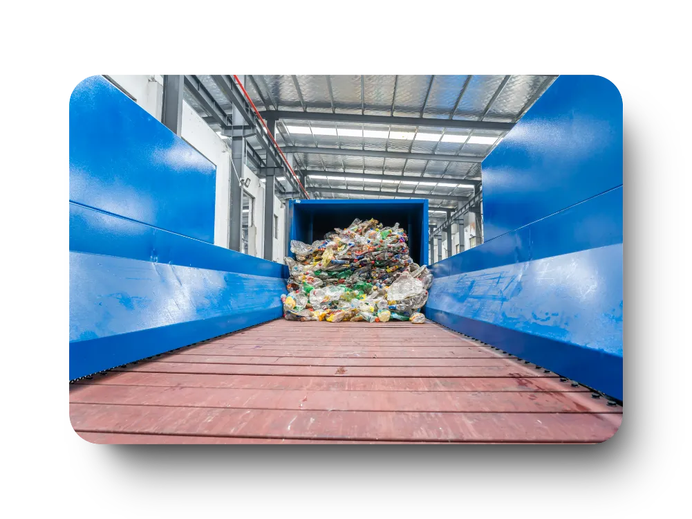 Plastic waste on recycling plant conveyor belt.